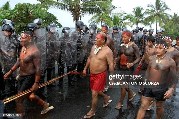 Indigenous members of the Yanomami tribe pass military policemen 22 April 2000 in a march in Coroa Vermelha, Brazil. Tribe members are marching to...