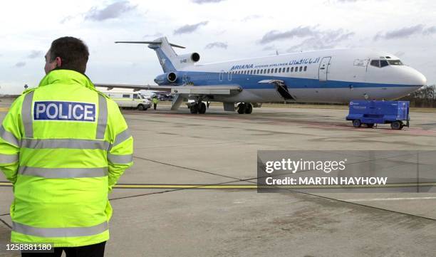 Police officer views at Stansted 10 February 2000 the hijacked Afghan Boeing 727 aircraft whose passengers ordeal finished in the early hours of this...