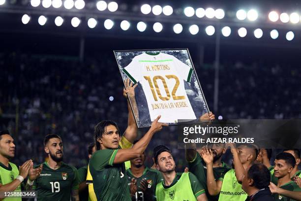 Bolivia's forward Marcelo Martins is honored for his 102 matches with the Bolivian national team during the friendly football match between Bolivia...