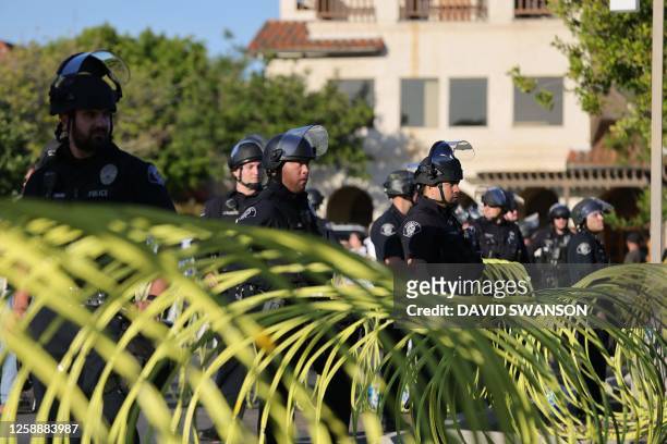 Police separate protesters as they gather outside the Glendale Unified School District headquarters in Glendale, California, on June 20, 2023. Over...