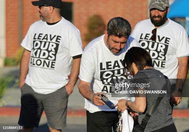 Shirts are sold as demonstrators gather outside the Glendale Unified School District headquarters in Glendale, California, on June 20, 2023. Over 300...