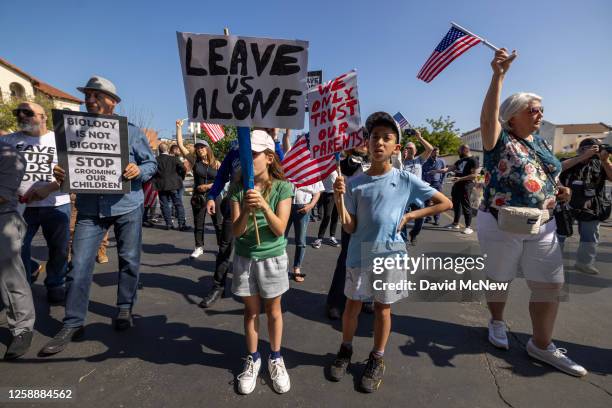 Children among anti-LGBTQ+ demonstrators hold signs outside a Glendale Unified School District Board of Education meeting on June 20, 2023 in...