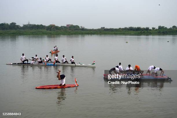 Participants perform yoga on the surface Yamuna River to mark the International Yoga Day celebrations on June 21, 2023 in New Delhi, India. It is...