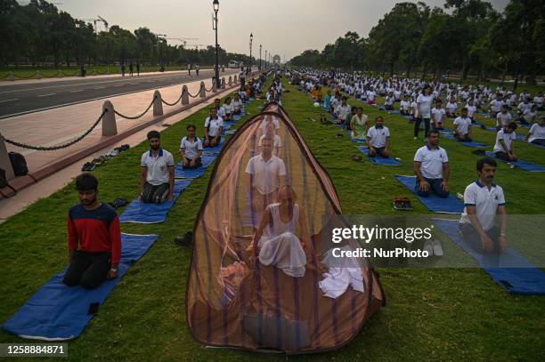 People perform Yoga on the occasion of International Yoga Day, on the lawns of Kartavya Path, formerly known as Rajpath, in front of India Gate, in...