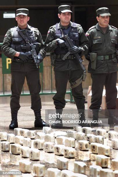 Police officers guard 25 August 2001 part of 35 million USD collected in an operation against drug traffickers in Bogota, Colombia. The police, along...