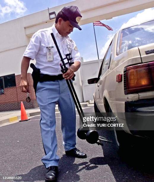 Security agent checks an incoming vehicle in the American Embassy in San Salvador, El Salvador. Security was doubled in the embassy due to recent...