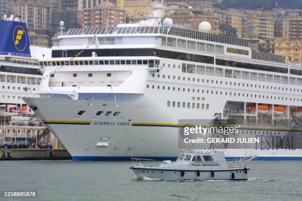 Police boat passes by the "European Vision" cruiser where the Group of Eight leaders will reside except US President Georges W. Bush who stays in a...