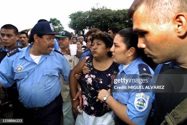 Carmen Matus attends her daughter Jessenia's funeral under police escort, 21 June 2001 in Managua, Nicaragua. Jessenia Matus died after 10 days in a...