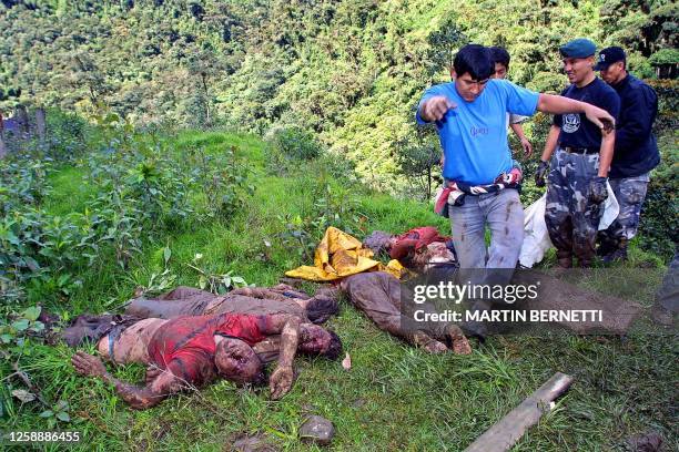 Man helps the police to line up corpses, so that they can be recognized by their families, that were caught in the mudslides in Guango, Mexico, 13...