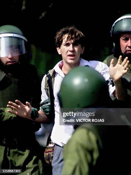 Student is detained by anti-riot police officers in Santiago, Chile on April 12, 2001. Un estudiante de secundaria es detenido por policias...