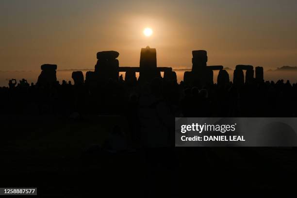 The sun rises at Stonehenge, near Amesbury, in Wiltshire, southern England on June 21 during the Summer Solstice festival, which dates back thousands...