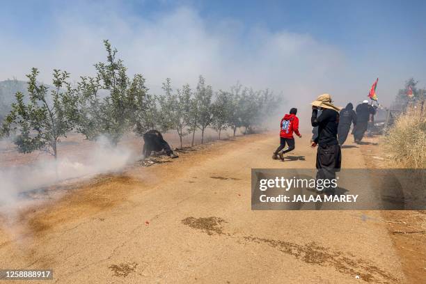 Tear gas fumes fill the air as members of the Druze community protest against an Israeli wind turbine project reportedly planned in agricultural...