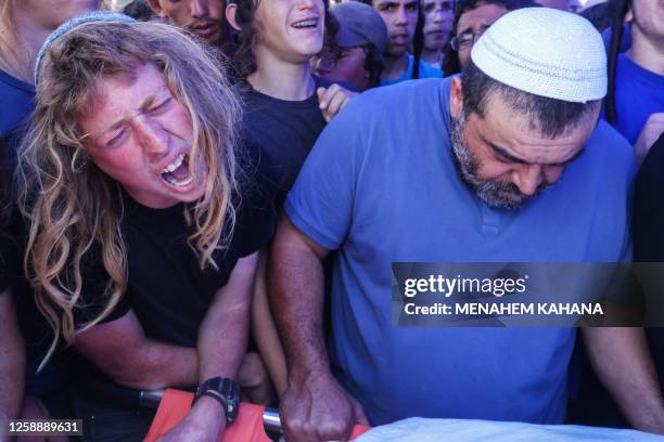 Relatives and friends mourn during the funeral of 17-year-old Israeli Nahman Mordof, at the cemetery in the Israeli settlement of Shilo, in the...