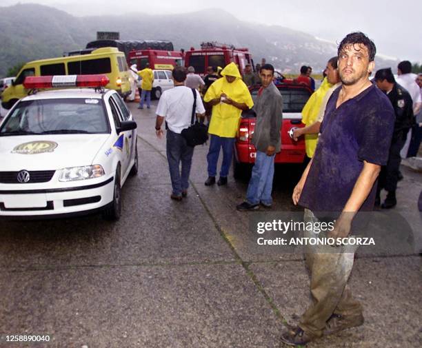 Hans Braemer, one of the first to arrive at the sight of the plane crash observes the arriving rescue workers in Nitoroi, Brazil 27 Septermber 2001....