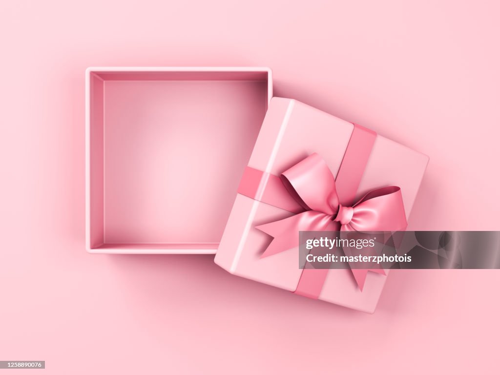 Blank pink pastel color present box or open gift box with pink ribbon and bow isolated on pink pastel color background with shadow top view
