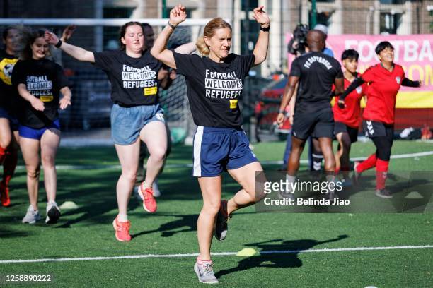 Kim Leadbeater, MP for Batler and Spen in Yorkshire warms up with players ahead of the football game on June 21, 2023 in London, England. For Refugee...