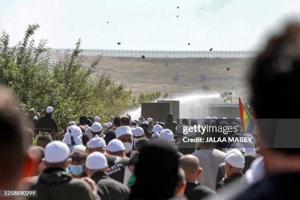 Stones and thrown and water cannon is deployed as members of the Druze community gather in a protest against an Israeli wind turbine project...