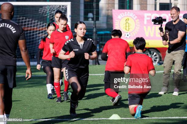 Players of Afghan National Development Squad - Girl Power warm up ahead of the football game on June 21, 2023 in London, England. For Refugee week...