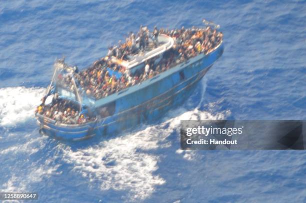 This undated handout image provided by Greece's coast guard, appear to show an overcrowded fishing boat that later capsized and sank off southern...