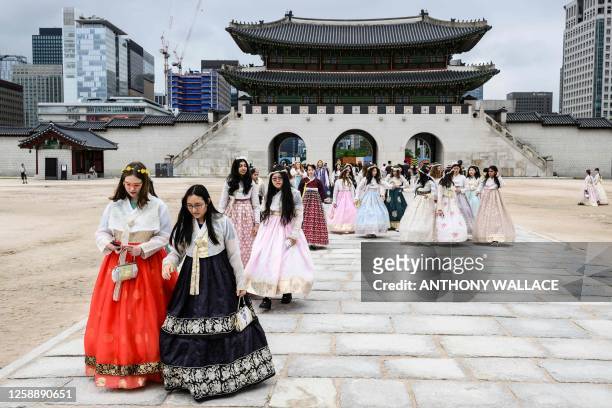 People wearing the traditional hanbok clothing visit the Gyeongbokgung Palace in central Seoul on June 21, 2023.