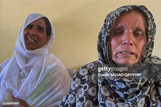 In this picture taken on June 20 Shahnaz Bibi , mother of Inham Shafat, and Tasleem Bibi , mother of Akash Gulzar, weep for their sons after they...