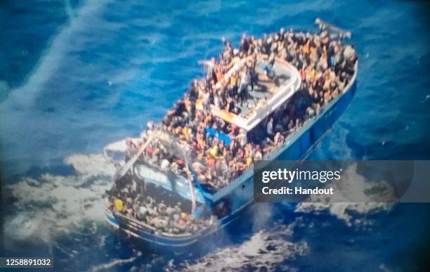 This undated handout image provided by Greece's coast guard, appear to show an overcrowded fishing boat that later capsized and sank off southern...