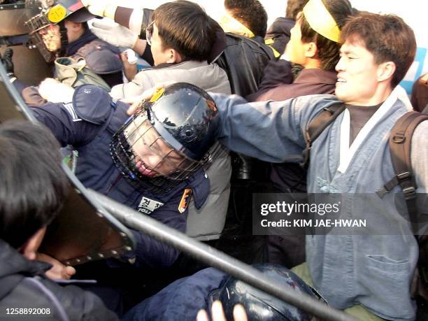 South Korean riot police battle with anti-US protesters, 20 February 2002, during a demonstration in Seoul against US President George W. Bush's...