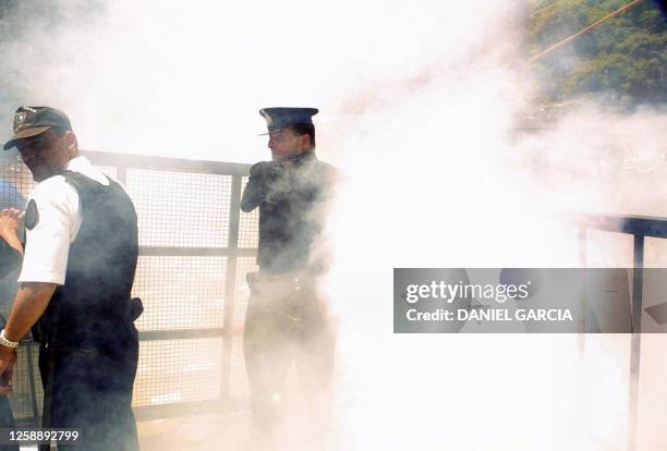 POlice officers continue to guard the chancillery as smoke surrounds the demonstration in Buenos Aires, Argentina 18 December 2001. Miembros de la...