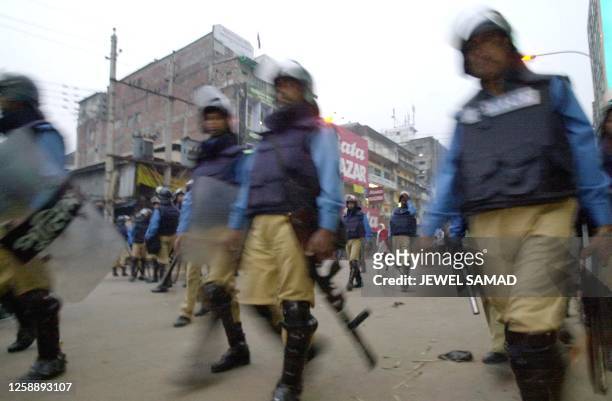 Riot police patrol in front of the opposition party, Awami League , office after an aborted protest march in Dhaka, 08 January 2002. Police fired...