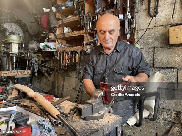 Lebanese Ali Hamadi, 68-year-old, works on a process of repair ancient gunpowder rifle, from the Ottoman period, in Beirut, Lebanon on June 15, 2023.