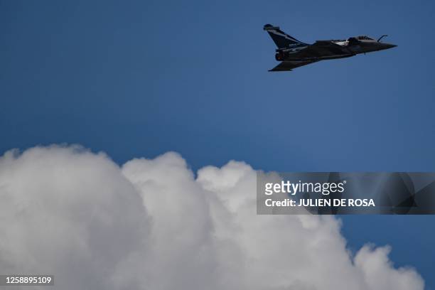 This photograph taken on June 21, 2023 shows a Rafale fighter jet performing an exhibition flight demonstration during the International Paris Air...