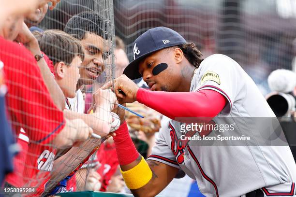 Ronald Acuna Jr. #13 of the Atlanta Braves signs autographs for fans prior to the game against the Philadelphia Phillies on June 20, 2023 at Citizens...