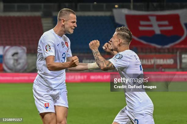 Denis Vavro of Slovakia celebrates after scoring his team's first goal with teammates during the UEFA EURO 2024 qualifying round group J match...
