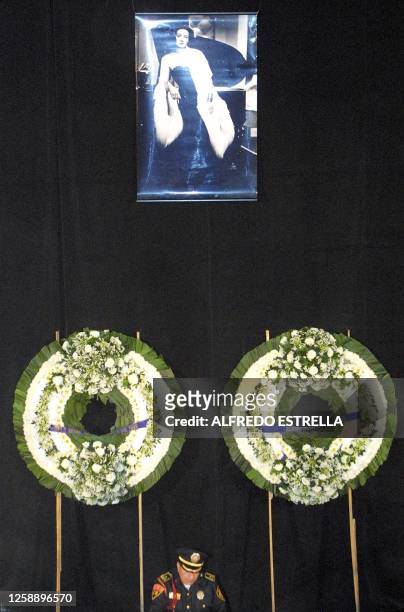 This photo shows a policeman guarding an homage to the late actress Maria Felix in the Palacio de Bellas Artes in Mexico City, 08 April 2002. Un...