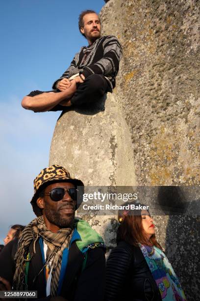 Spiritually-minded revellers celebrate the summer Solstice on the stones at the ancient late-Neolithic stones of Stonehenge, on 21st June 2023, in...