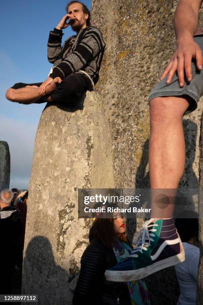 Spiritually-minded revellers celebrate the summer Solstice on the stones at the ancient late-Neolithic stones of Stonehenge, on 21st June 2023, in...