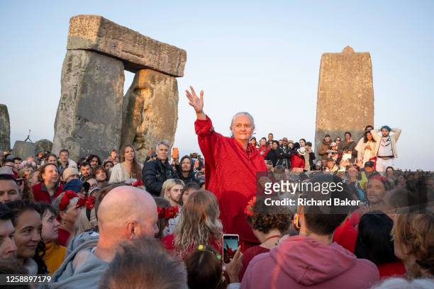 Spiritually-minded percussion revellers celebrate the summer Solstice at the ancient late-Neolithic stones of Stonehenge, on 21st June 2023, in...