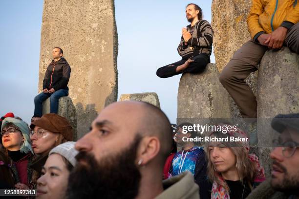 Spiritually-minded revellers celebrate the summer Solstice on the stones at the ancient late-Neolithic stones of Stonehenge, on 21st June 2023, in...