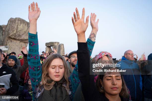 Spiritually-minded percussion revellers celebrate the summer Solstice at the ancient late-Neolithic stones of Stonehenge, on 21st June 2023, in...