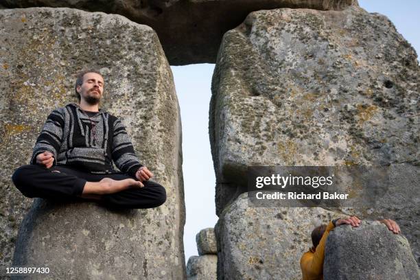 Spiritually-minded revellers celebrate the summer Solstice on the stones at the ancient late-Neolithic stones of Stonehenge, on 21st June 2023, in...