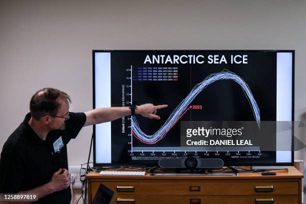 Professor of the British Antarctic Survey explains a graph on the situation of the Anatartic sea ice at different years during a visit of the British...