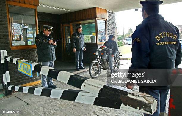 Security officers of the private security company Beynor monitor access 04 September, 2002 to the Hindú Club de Don Torcuato, a country club with...
