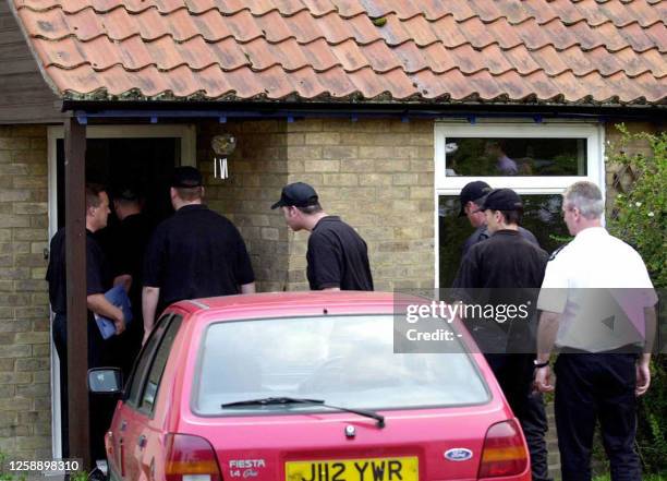Caretaker Ian Huntley's home is searched by the police in the village of Soham some 160 km north of London, 17 August 2002. Huntley and his...