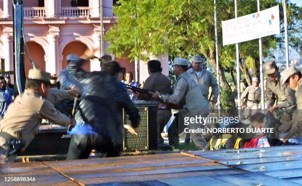 Anti-riot police hold bak demonstrators in front of Congress in Asuncion, 15 July 2002. AFP PHOTO/Norberto DUARTE Policías reprimen a manifestantes...