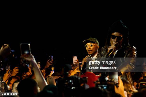 Music producer Pharrell Williams, menswear creative director at Louis Vuitton, left, performs with musician Jay-Z at the Louis Vuitton Spring-Summer...