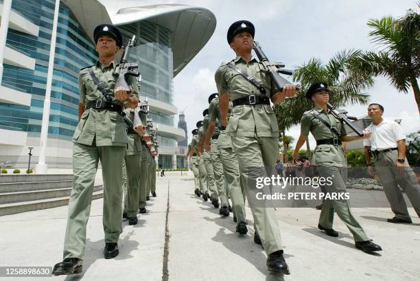 Hong Kong police rehearse outside the Convention and Exhibition Centre during preparations for the fifth anniversary handover celebrations 28 June...