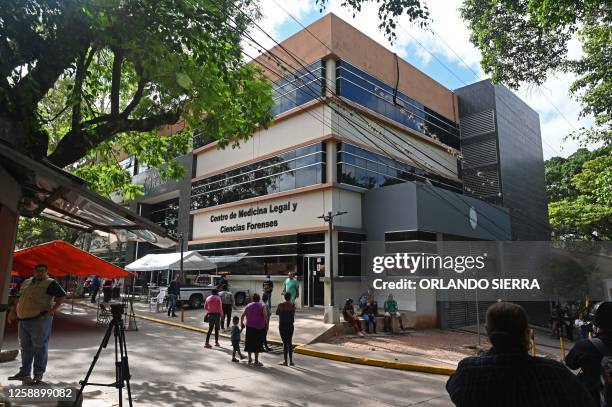 Members of the press and relatives of the 46 dead women during a fire following a brawl between inmates of the Women's Social Adaptation Center...