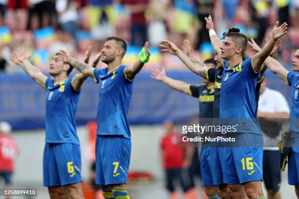 Taras Stepanenko , Andriy Yarmolenko and Vitaliy Mykolenko of Ukraine salute their team's fans after the UEFA EURO 2024 European qualifying soccer...