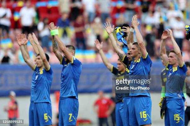 Taras Stepanenko , Andriy Yarmolenko , Vitaliy Mykolenko and Viktor Tsygankov of Ukraine salute their team's fans after the UEFA EURO 2024 European...