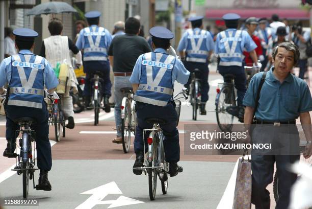Riding Japanese policemen patrol 12 June 2002 around streets of the Osaka's Nagai Stadium, a few hours before the beginning of the FIFA World Cup F...